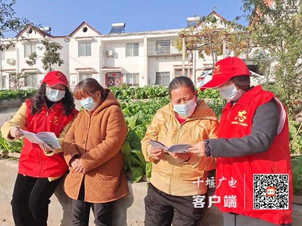 教师志愿者向社区居民宣传文明知识中